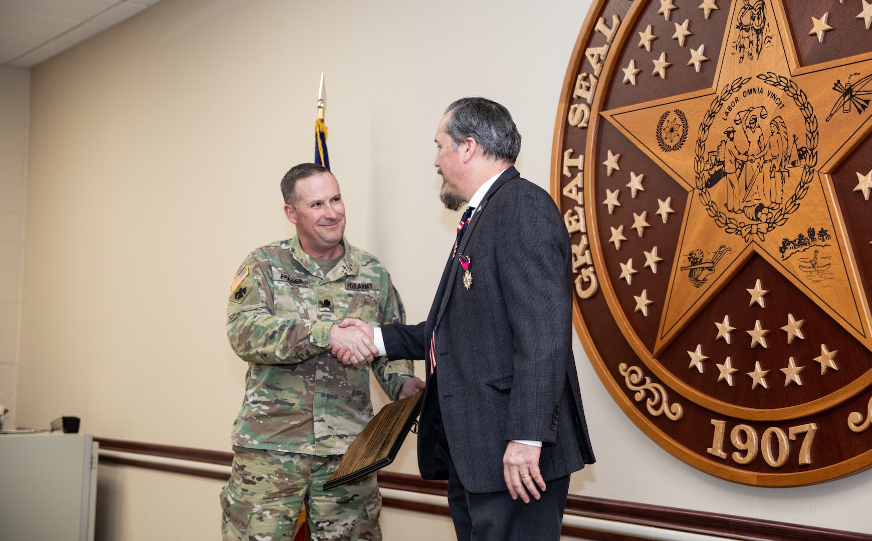 Oklahoma National Guard Col. Thomas Mackey, former deputy United States Property and Fiscal Office, receives an award for his many years of service during his retirement ceremony at Joint Force Headquarters in Oklahoma City, Oklahoma, Jan. 22, 2022. Mackey’s career spanned 34 years and included three deployments. (Oklahoma National Guard photo by Spc. Danielle Rayon)