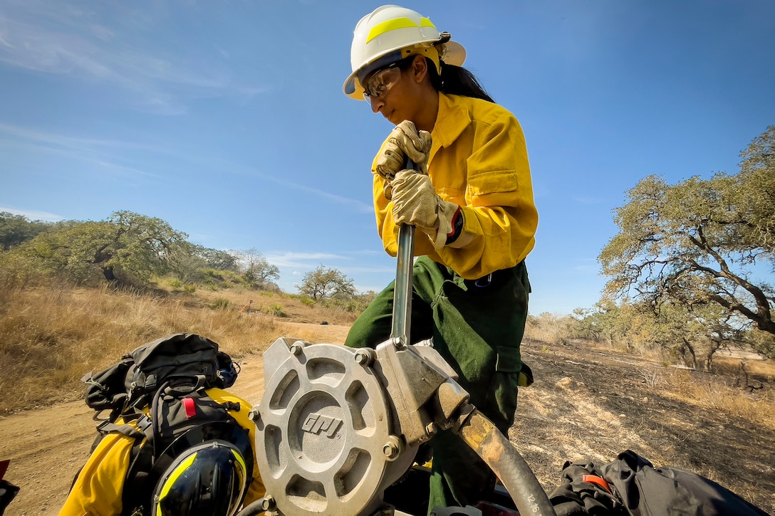 Fire and emergency services personnel work in a desert-like area.