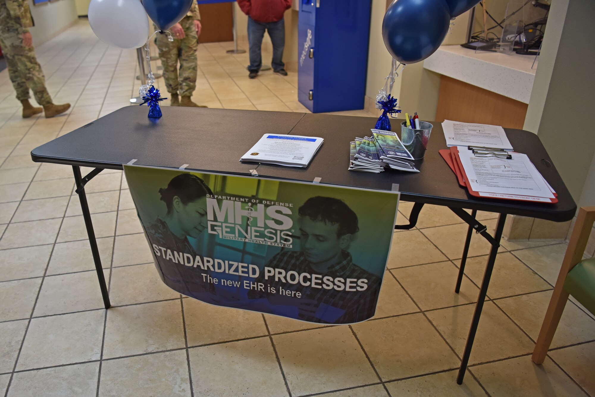 The MHS Genesis information table contains printouts for beneficiaries at the Ross Clinic, Jan. 24, 2022. MHS Genesis is an electronic health record that gives patients access to monitor their health information, see laboratory test results, make appointments and exchange secure messages with their care team. (U.S. Air Force photo by Staff Sgt. Jermaine Ayers)