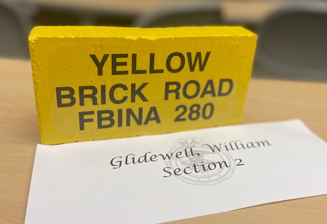 The "Yellow Brick Road" brick of OSI SA William Glidewell symbolizes his completion of the FBI National Academy's physically demanding 6.1-mile final test course as a graduate of the FBI NA. When (and if) students complete this arduous test, they receive a yellow brick to memorialize their achievement. (FBI NA photo)