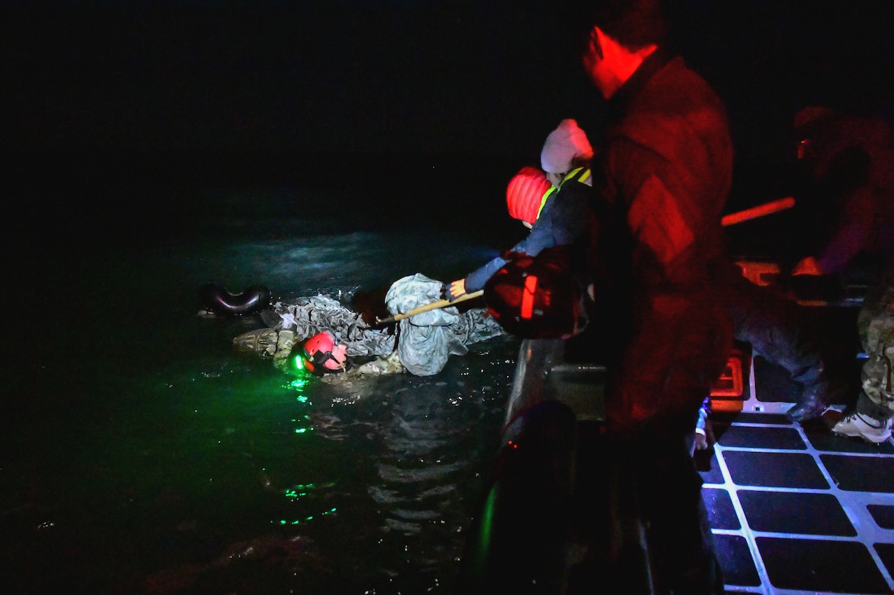 Airmen rescue a fellow airman after landing into a body of water during training.