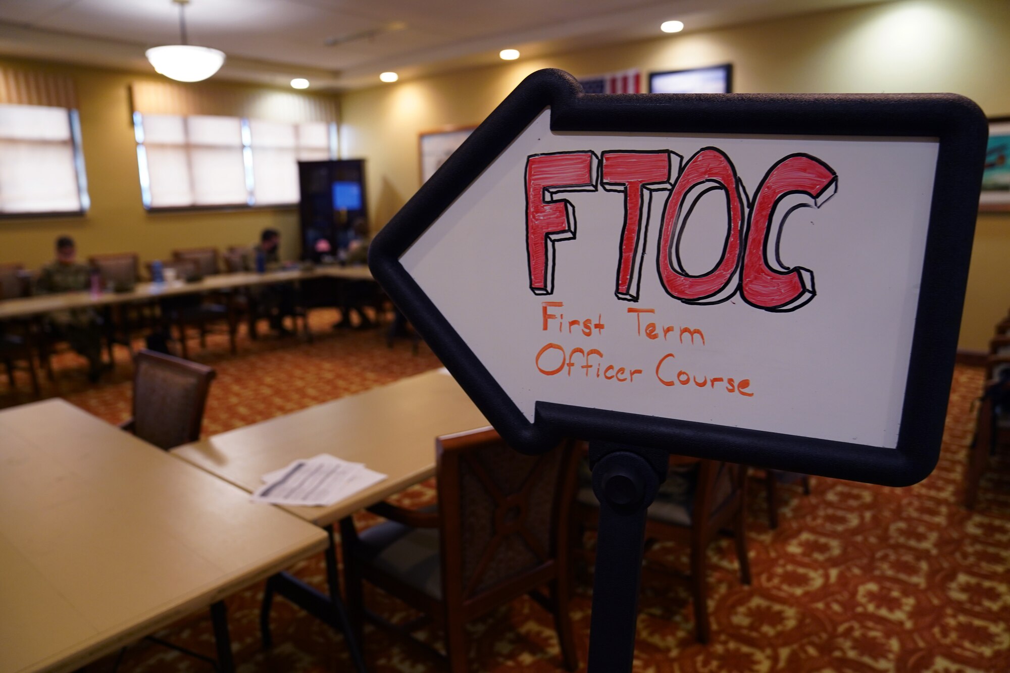 An First Term Officers Course entrance sign is displayed before the FTOC classroom in the Bay Breeze Event Center at Keesler Air Force Base, Mississippi, January 19, 2022. The FTOC was created to develop the job and leadership skillsets of first-term officers. (U.S. Air Force photo by Senior Airman Seth Haddix)