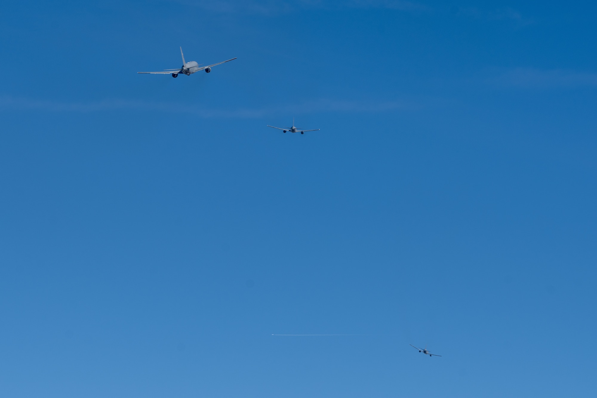 Three KC-46A Pegasus tankers ascend after takeoff as part of a minimum interval take off exercise Jan. 13, 2022, at McConnell Air Force Base, Kansas.