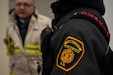 Firefighters converse during a training exercise hosted by the Connecticut Air National Guard Fire Department Dec. 10, 2021, at Bradley Air National Base, Conn. The CTANG Fire Department collaborated with mutual aid partners to incorporate resources from various fire departments into its incident command system.