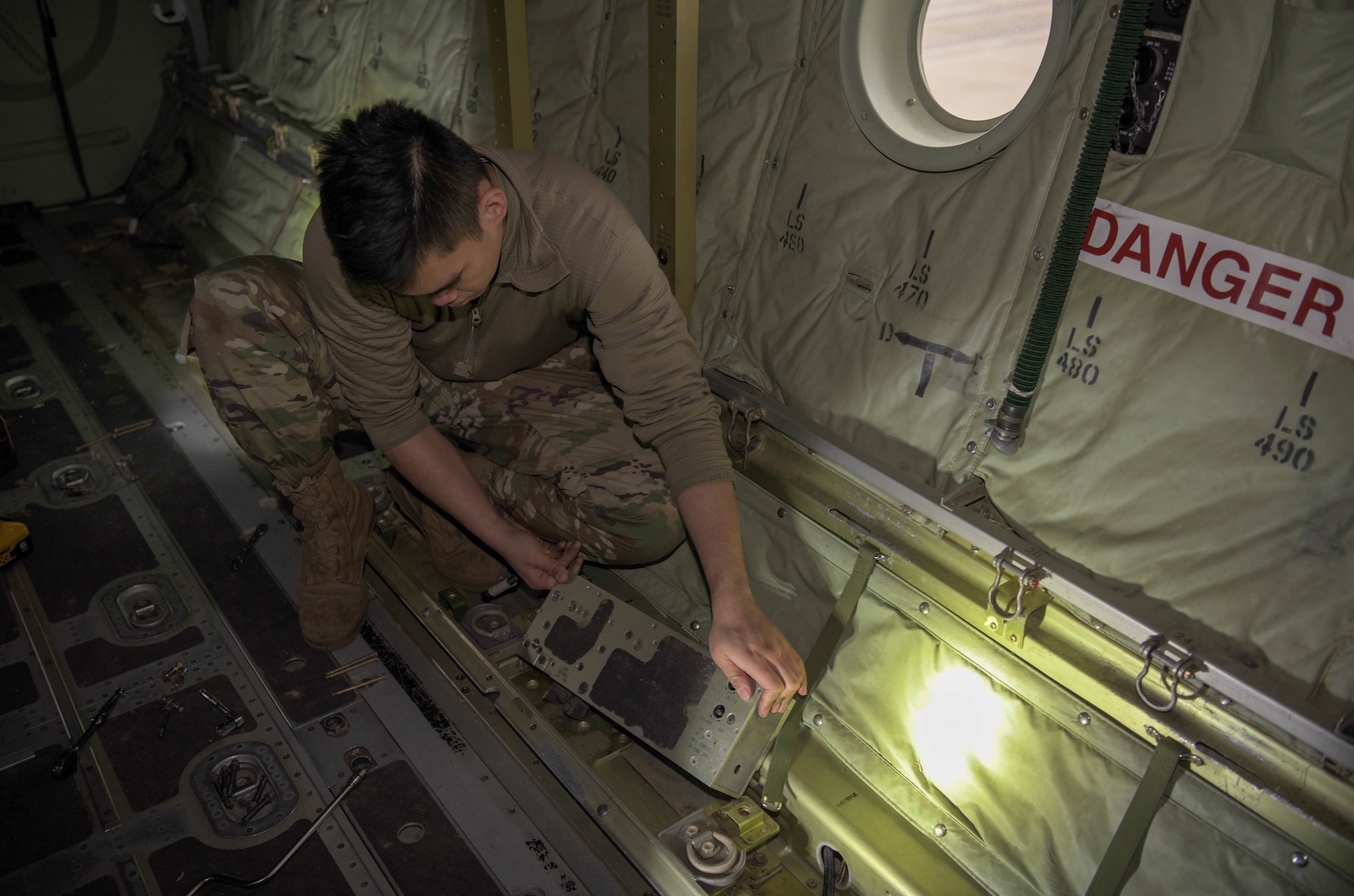 Airman removes equipment from aircraft.