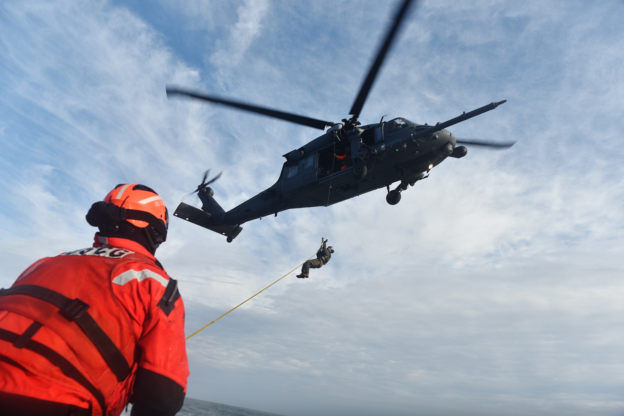 HAMPTON BAYS, NY -  Machinery Technician 2nd Class Benjamin Esposita helps wrangle a hoist line from an HH-60 Pavehawk from the 101st Rescue Squadron during training in the waters near US Coast Guard Station Shinnecock.

During this training, Guardian Angels from the 103rd RQS were lowered via hoist from an HH-60 Pavehawk onto the cutter's deck. After that, the aircraft practiced dropping and removing patient litters, before hoisting the Guardian Angels back up and returning to base.

