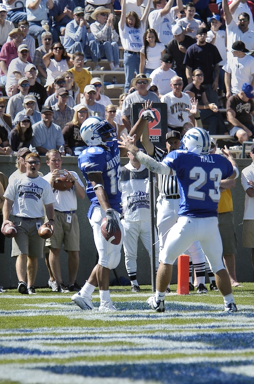 Football players celebrate.