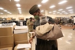 a soldier tries on a dress uniform cap