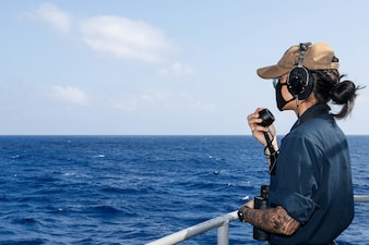 Seaman Johnnese Poomaihealani stands port life buoy watch on the fantail aboard USS Abraham Lincoln (CVN 72).