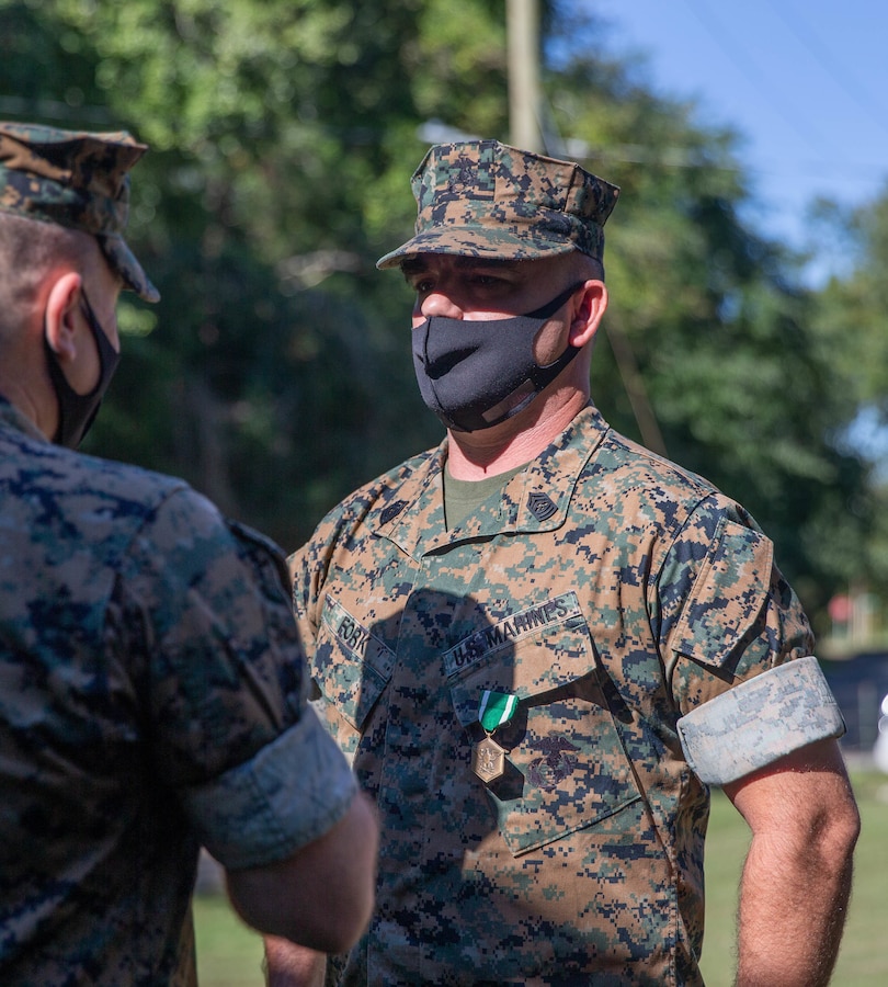 Master Sgt. Michael E. Fork with Training Command is awarded the Navy and Marine Corps Achievement Medal for his efforts in keeping training pipelines open and running during the COVID-19 pandemic on Marine Corps Base Quantico, Virginia, Oct. 1, 2021. Seven reserve Marines with Training Command were awarded for their creative problem solving and dedication to duty while serving on Marine Corps Base Quantico. (U.S. Marine Corps photo by Cpl. Michael Slavin)