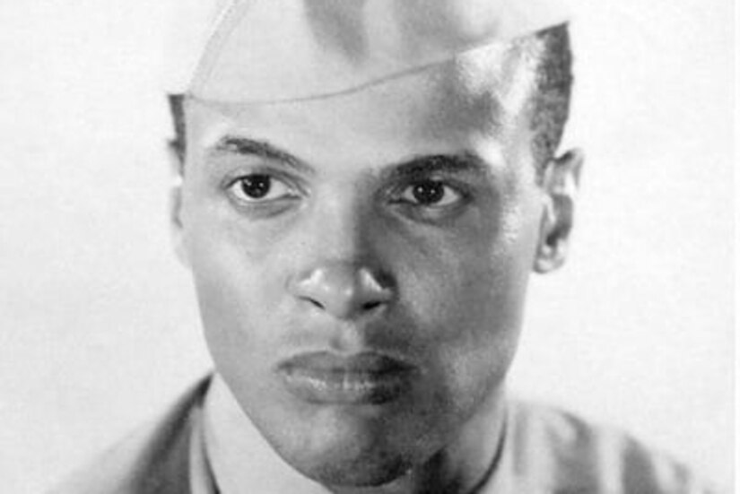 A sailor poses for a photo.