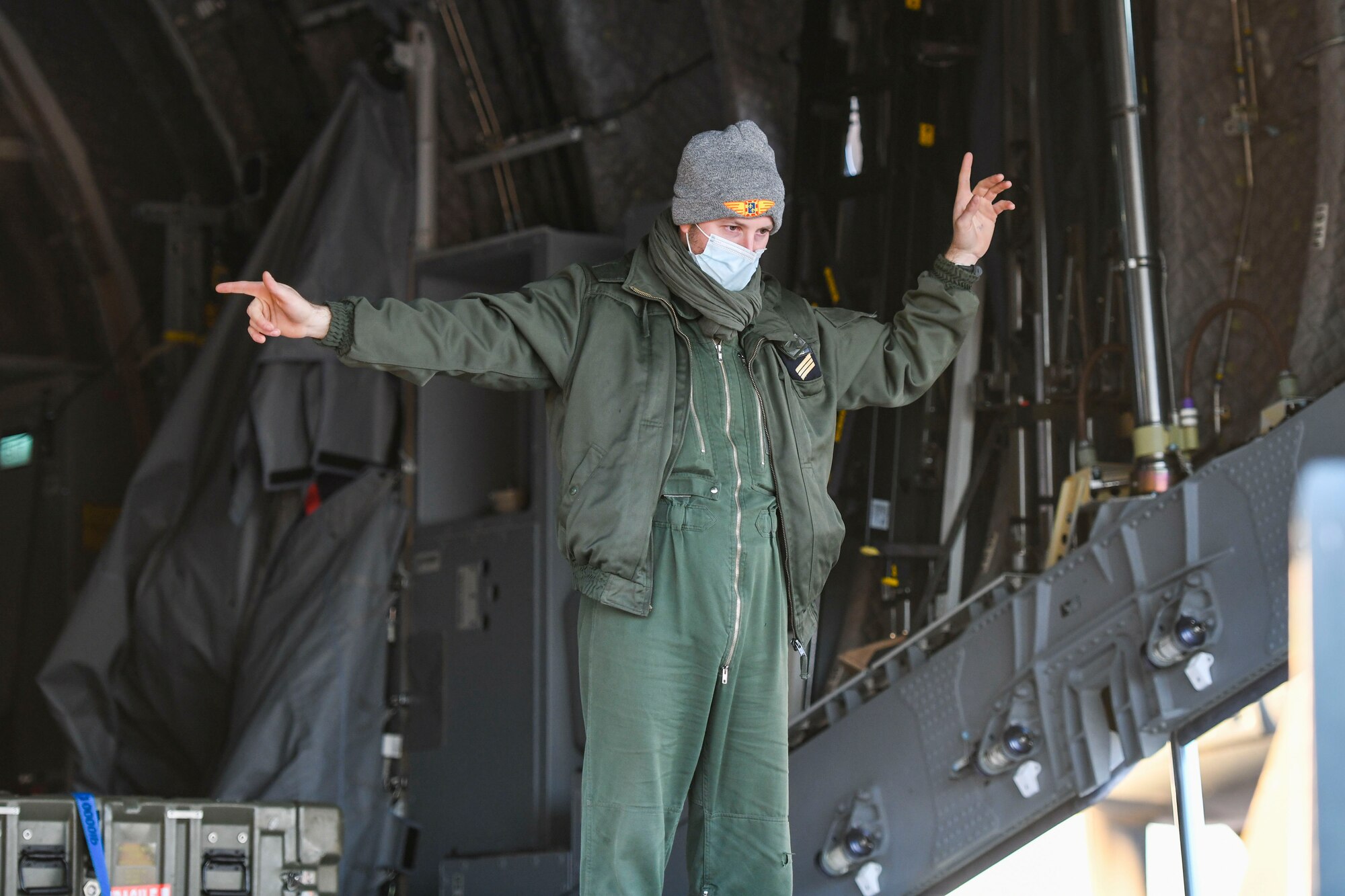 A member of the French Air and Space Force guides cargo onto a C-130J Super Hercules during Green Flag Little Rock 22-03