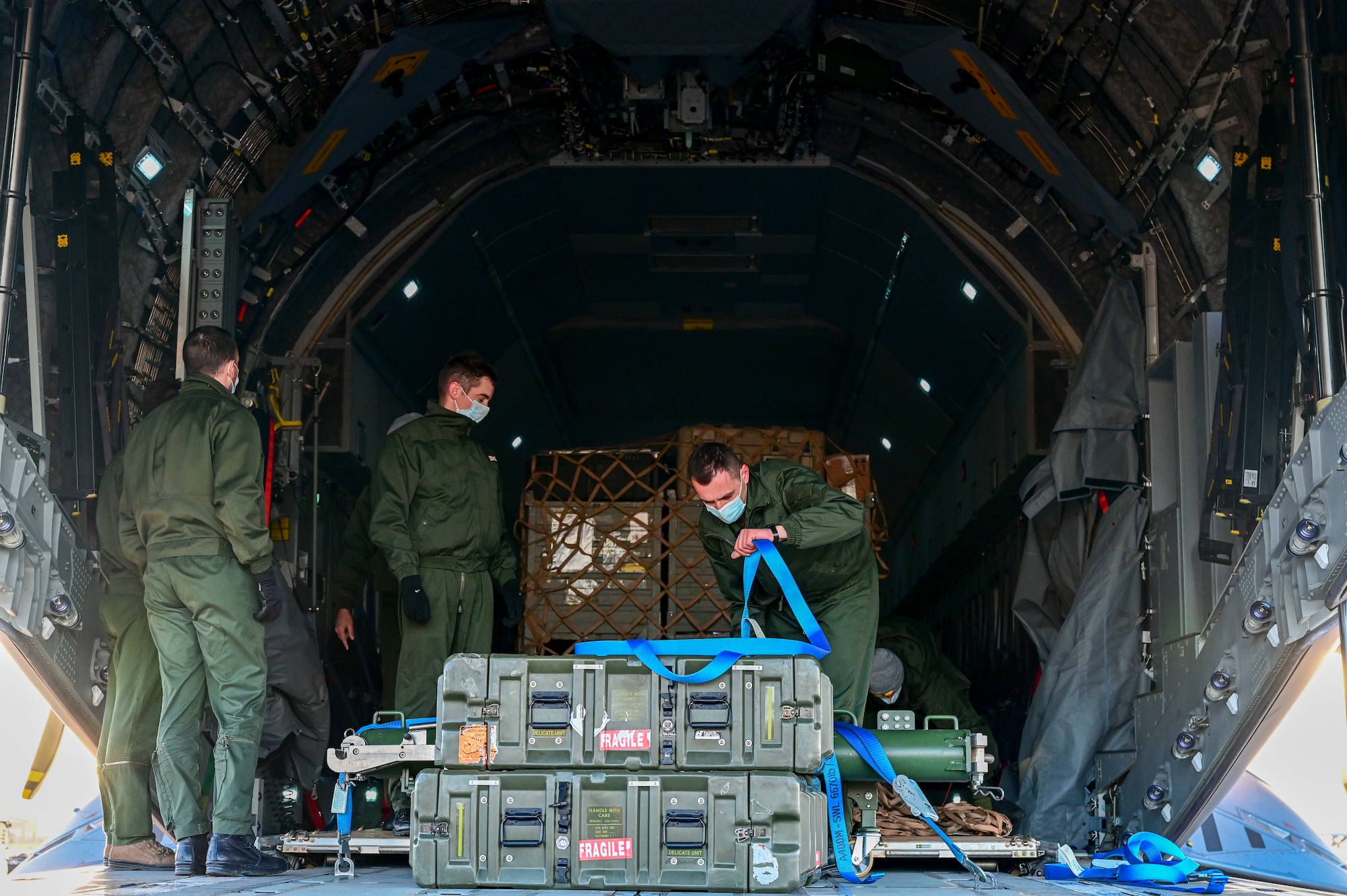 Members of the French Air and Space Force offload cargo from a French A400