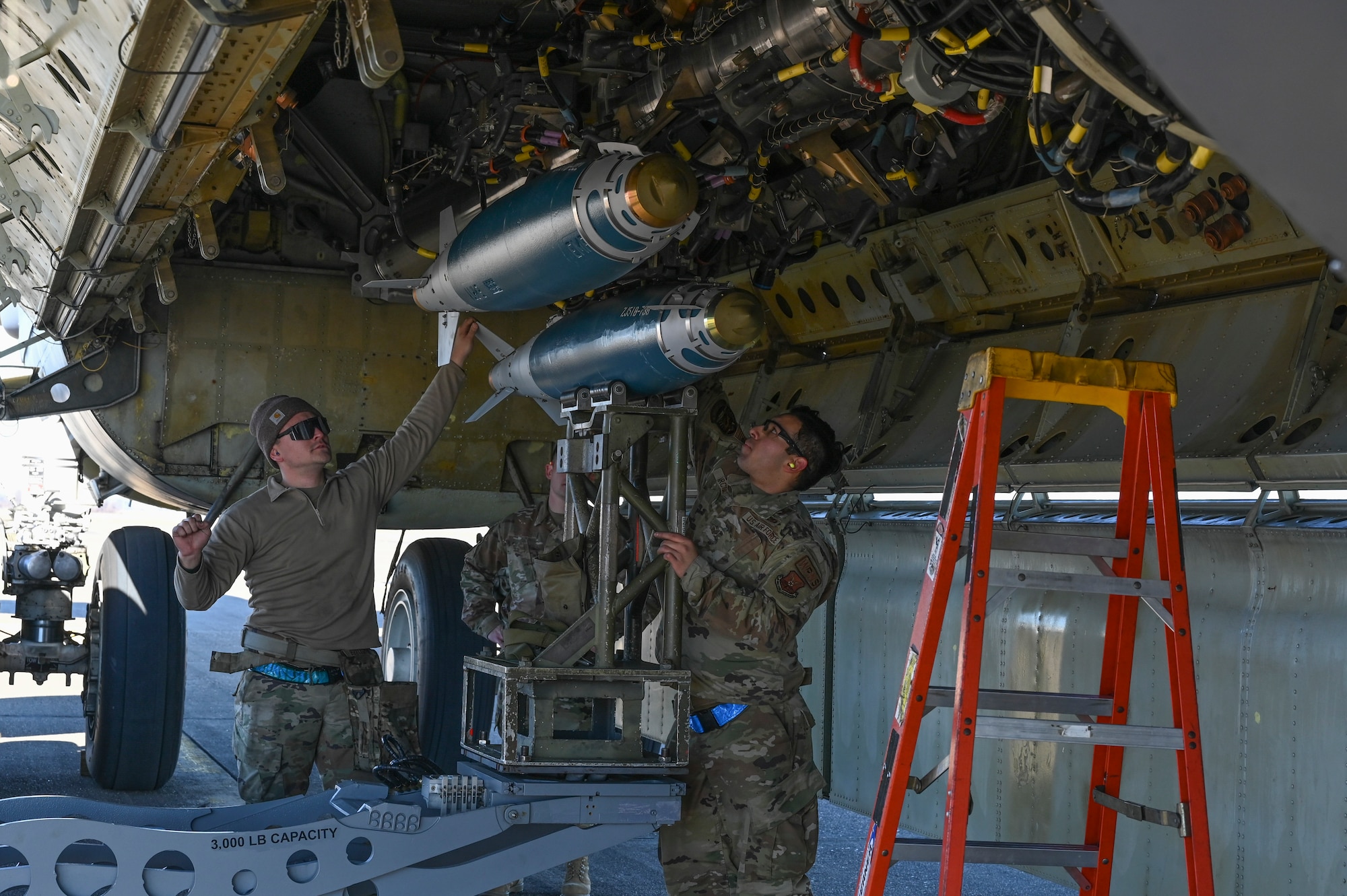 Airmen load a munition onto a B-52 Stratofortress