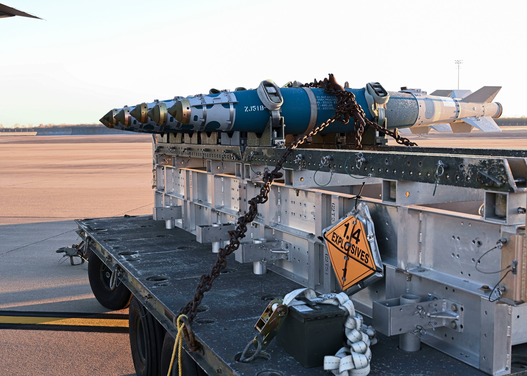 Munitions sit on the flighline before being loaded onto a C-130J Super Hercules