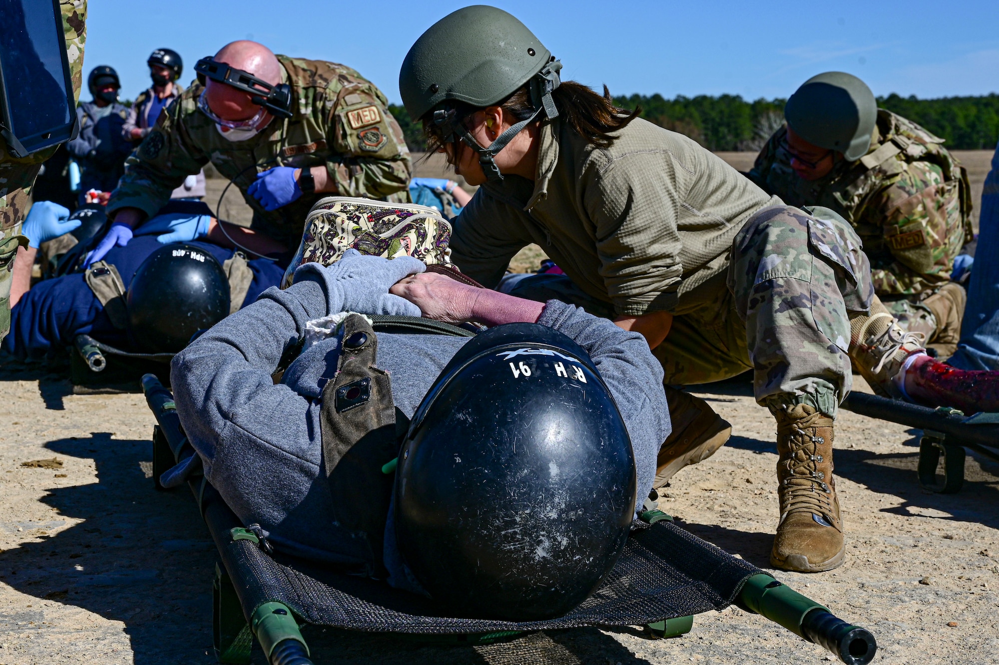 Aeromedical Evacuation technicians assist patients with simulated injuries during an Aeromedical Evacuation exercise
