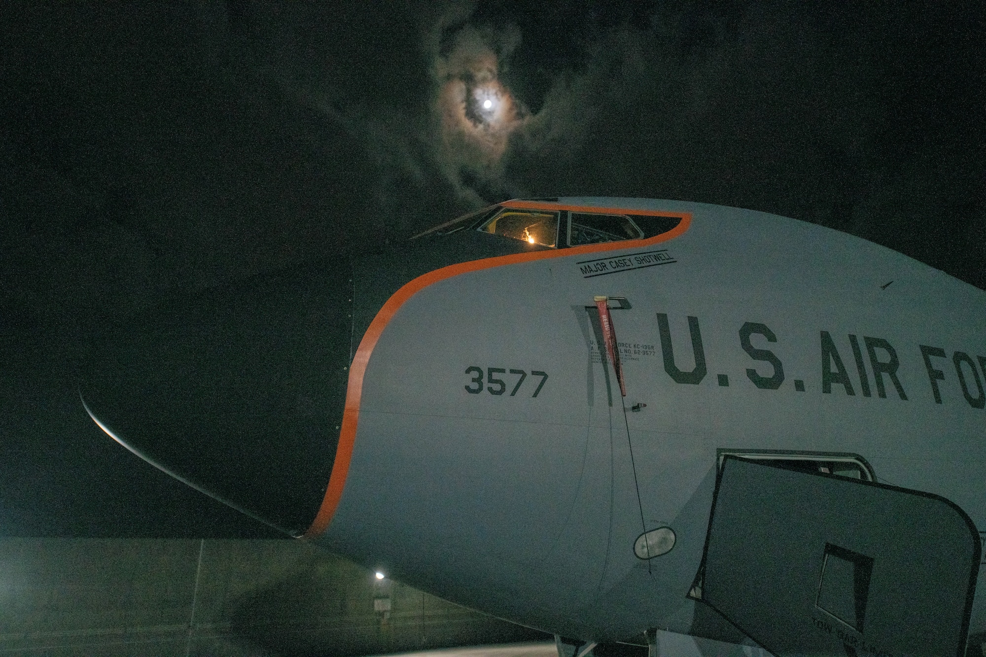 A plane sits in the moonlight