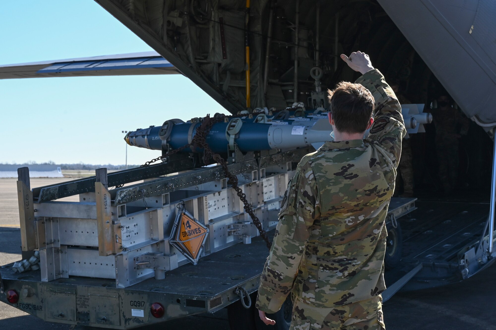 An Airman unloads munitions from a C-130J Super Hercules