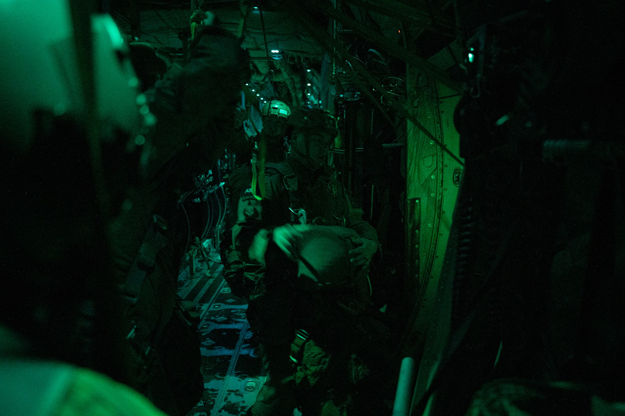 Army paratroopers with the 1st Battalion, 509th Infantry Regiment, prepare to jump out of a C-130J Super Hercules