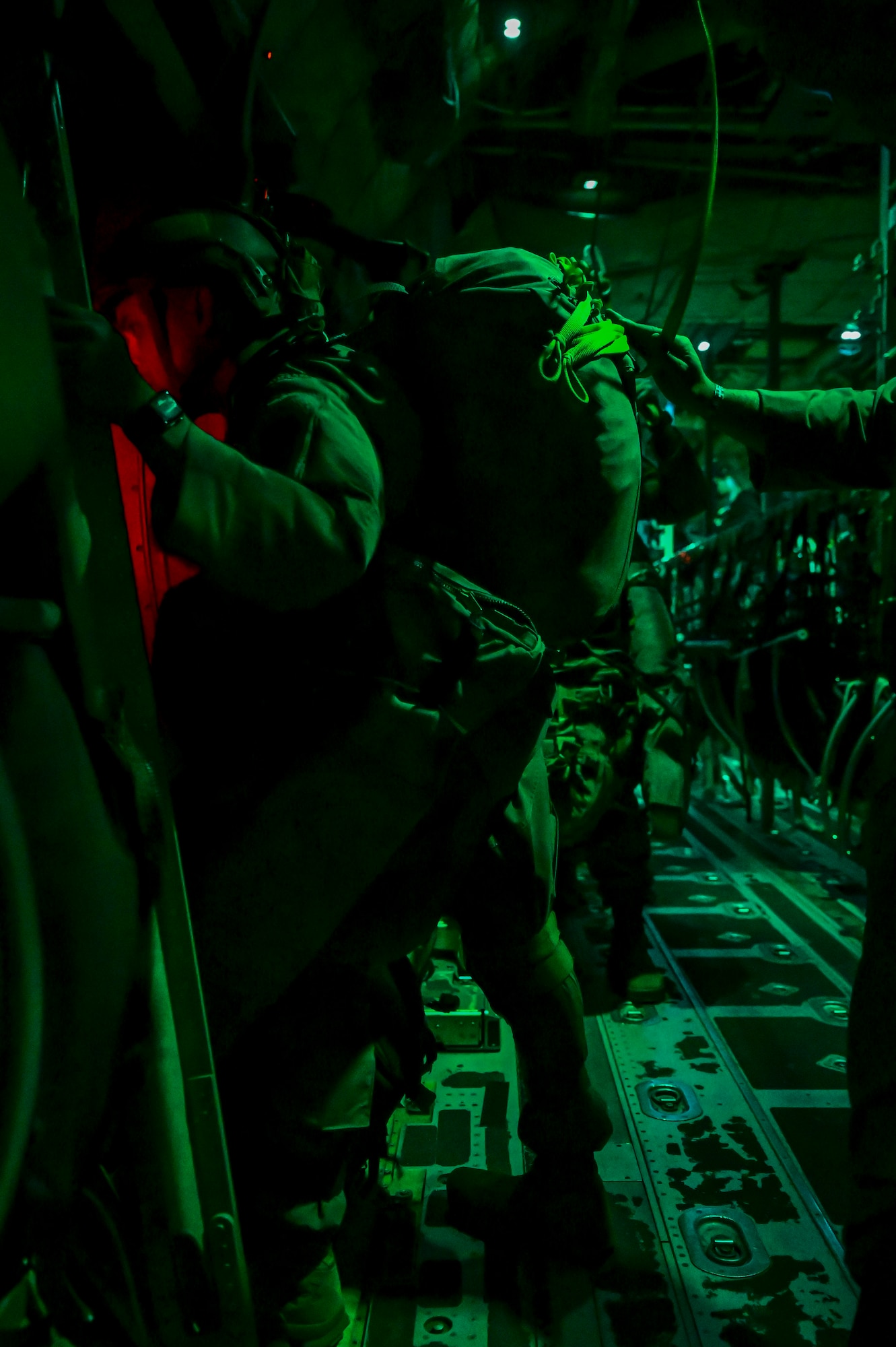 U.S. Army paratroopers from the 1st Battalion, 509th Infantry Regiment, prepare to jump from a C-130J Super Hercules