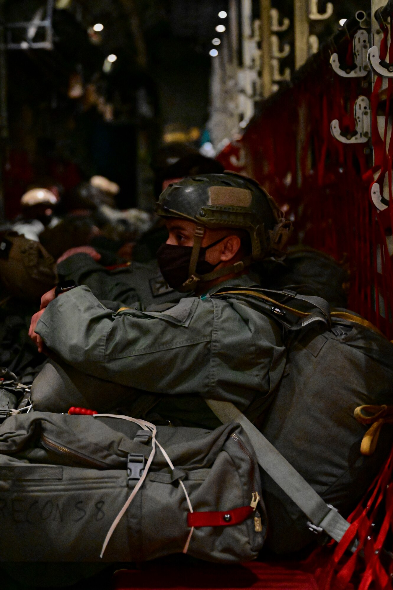 A U.S. Army paratrooper with the 1st Battalion, 509th Infantry Regiment, prepares to jump from a C-130J Super Hercules