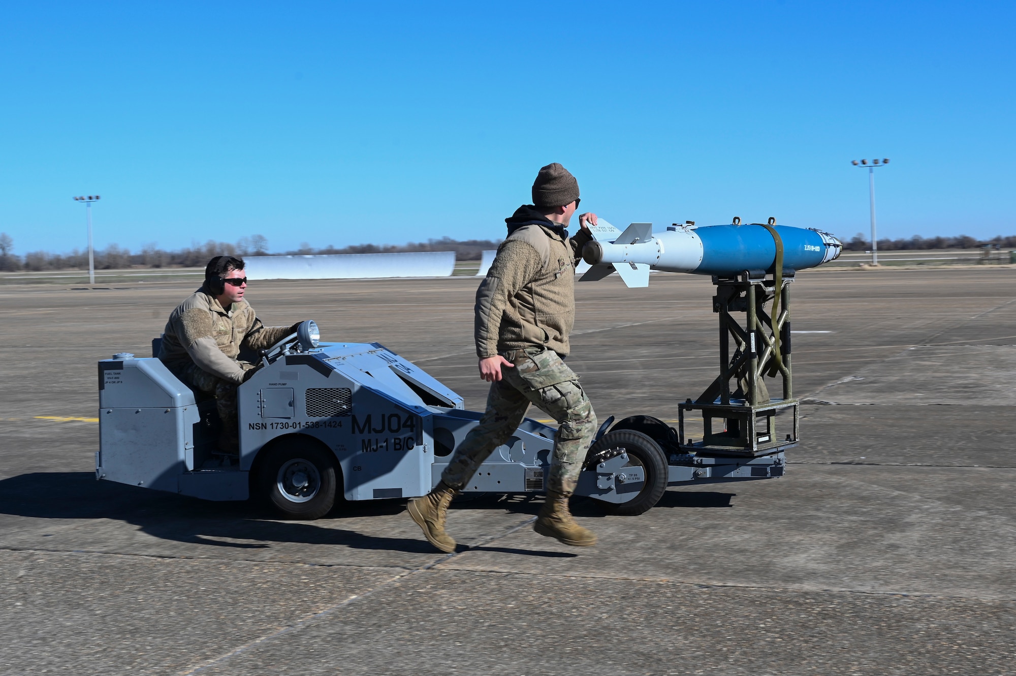 Airmen transfer a munition to a B-52 Stratofortress