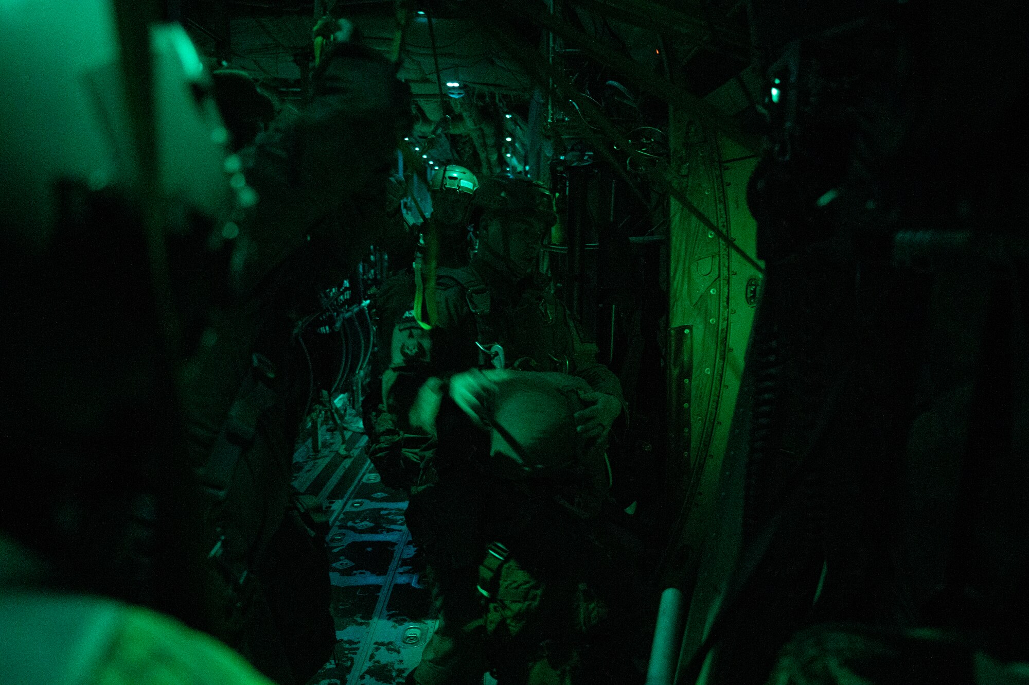 Army paratroopers with the 1st Battalion, 509th Infantry Regiment, prepare to jump out of a C-130J Super Hercules