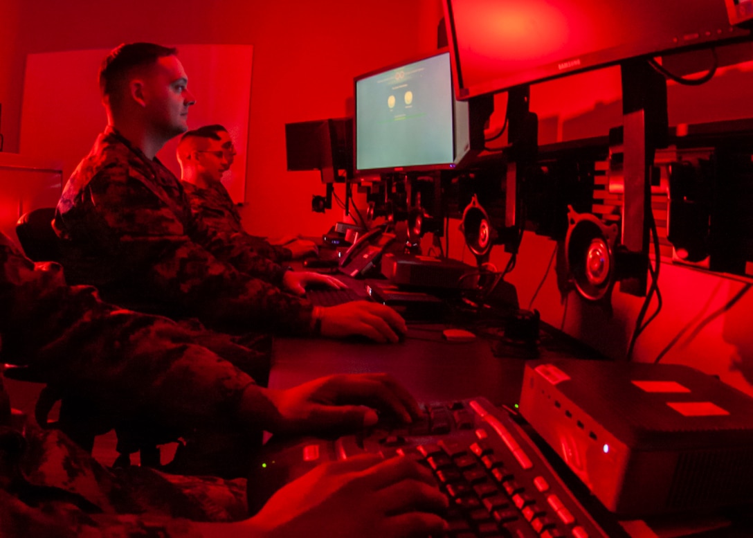 Marines with Marine Corps Forces Cyberspace Command pose for photos in cyber operations room at Lasswell Hall aboard Fort Meade, Md., Feb. 5, 2020. MARFORCYBER Marines conduct offensive and defensive cyber operations in support of United States Cyber Command and operate, secure and defend the Marine Corps Enterprise Network.