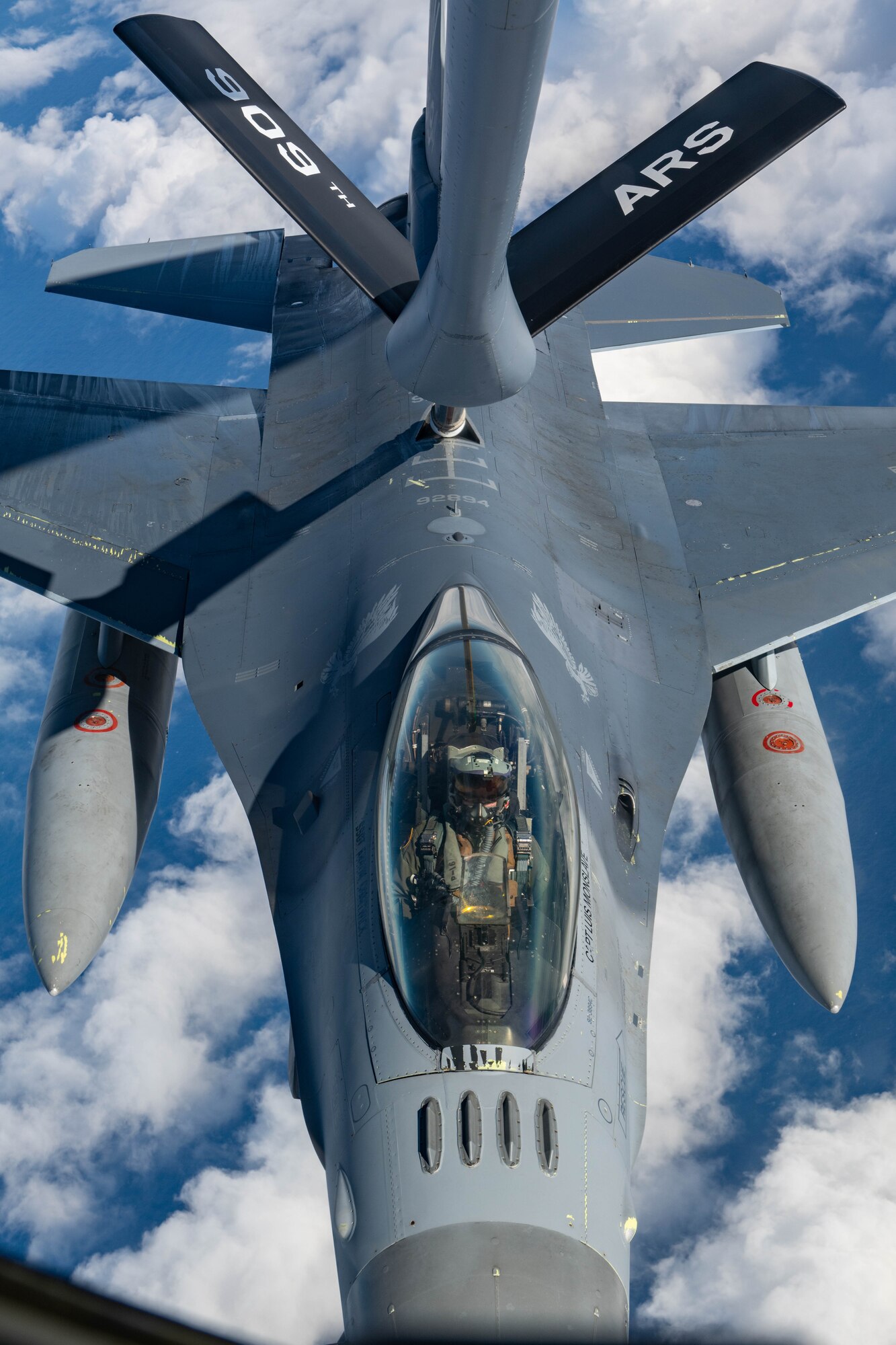 A jet gets refueled in the air by a plane