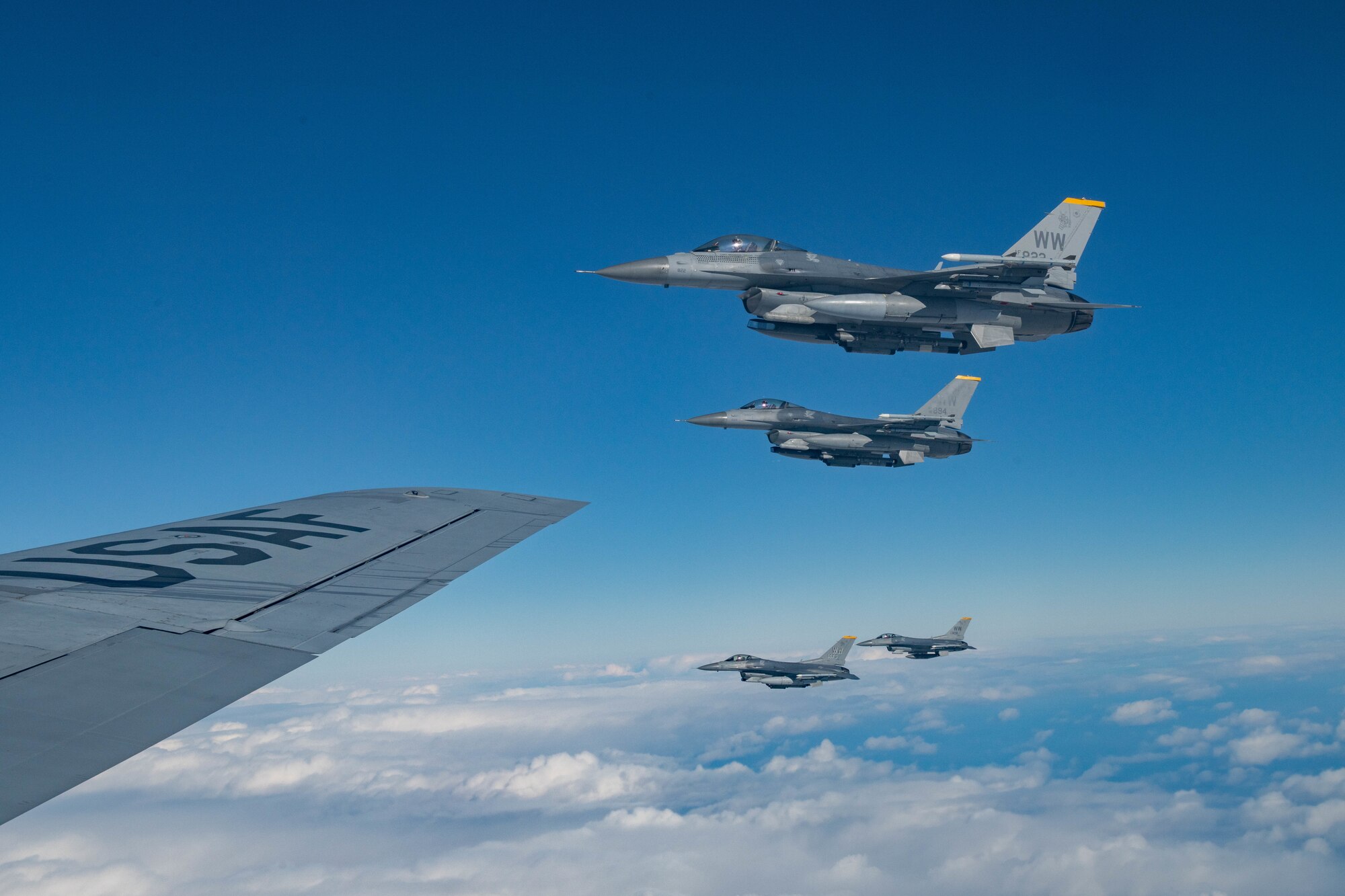 4 jets fly off the wing of a plane
