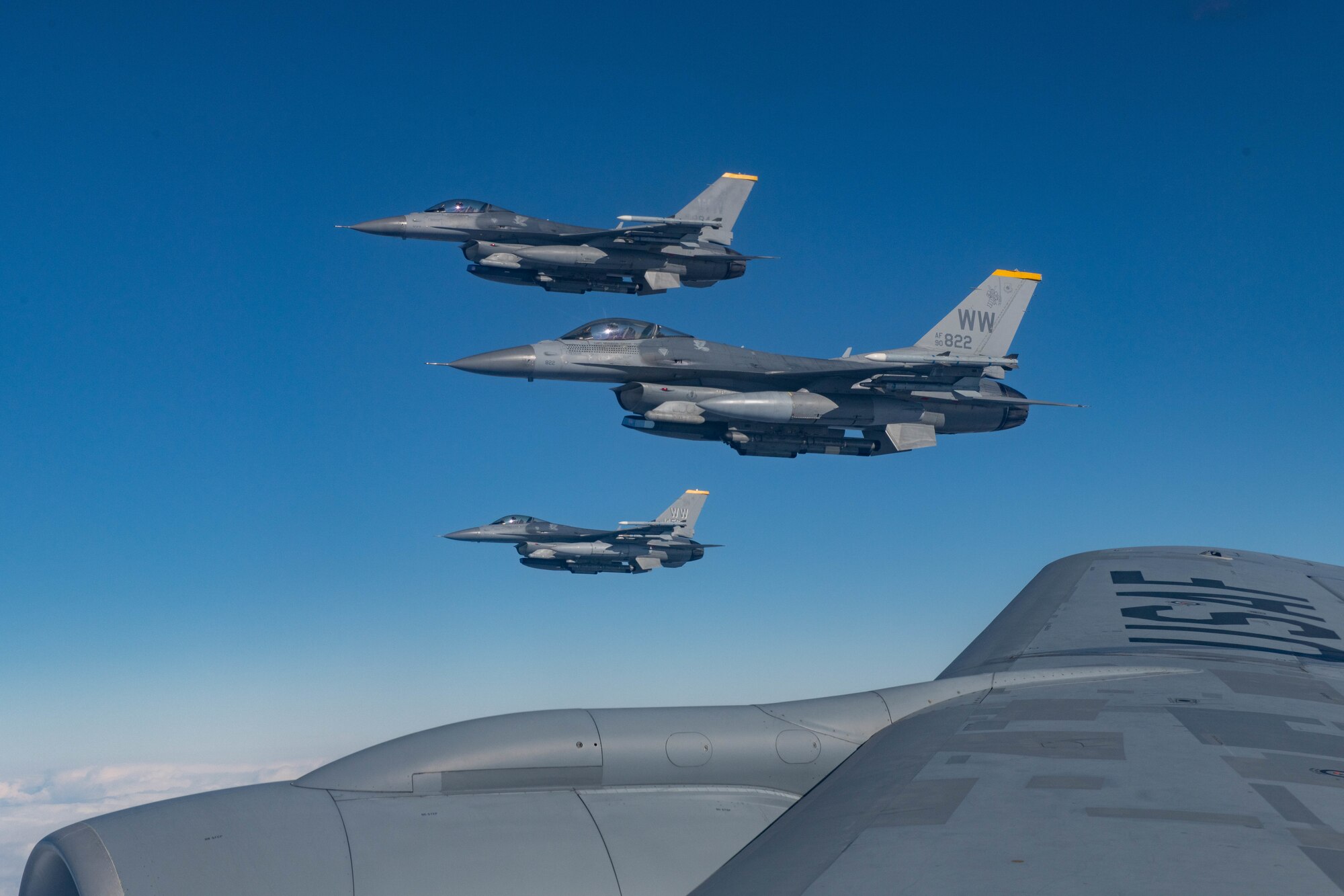 3 jets fly off the wing of a plane