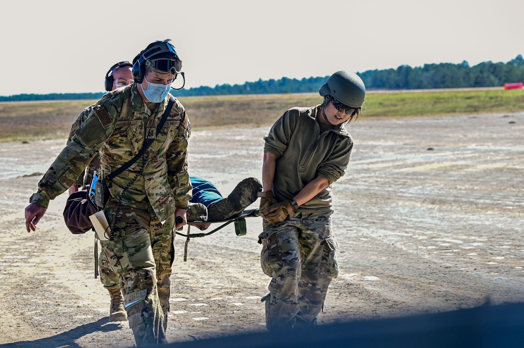 Technicians transport a patient with simulated injuries onto a C-17 Globemaster III