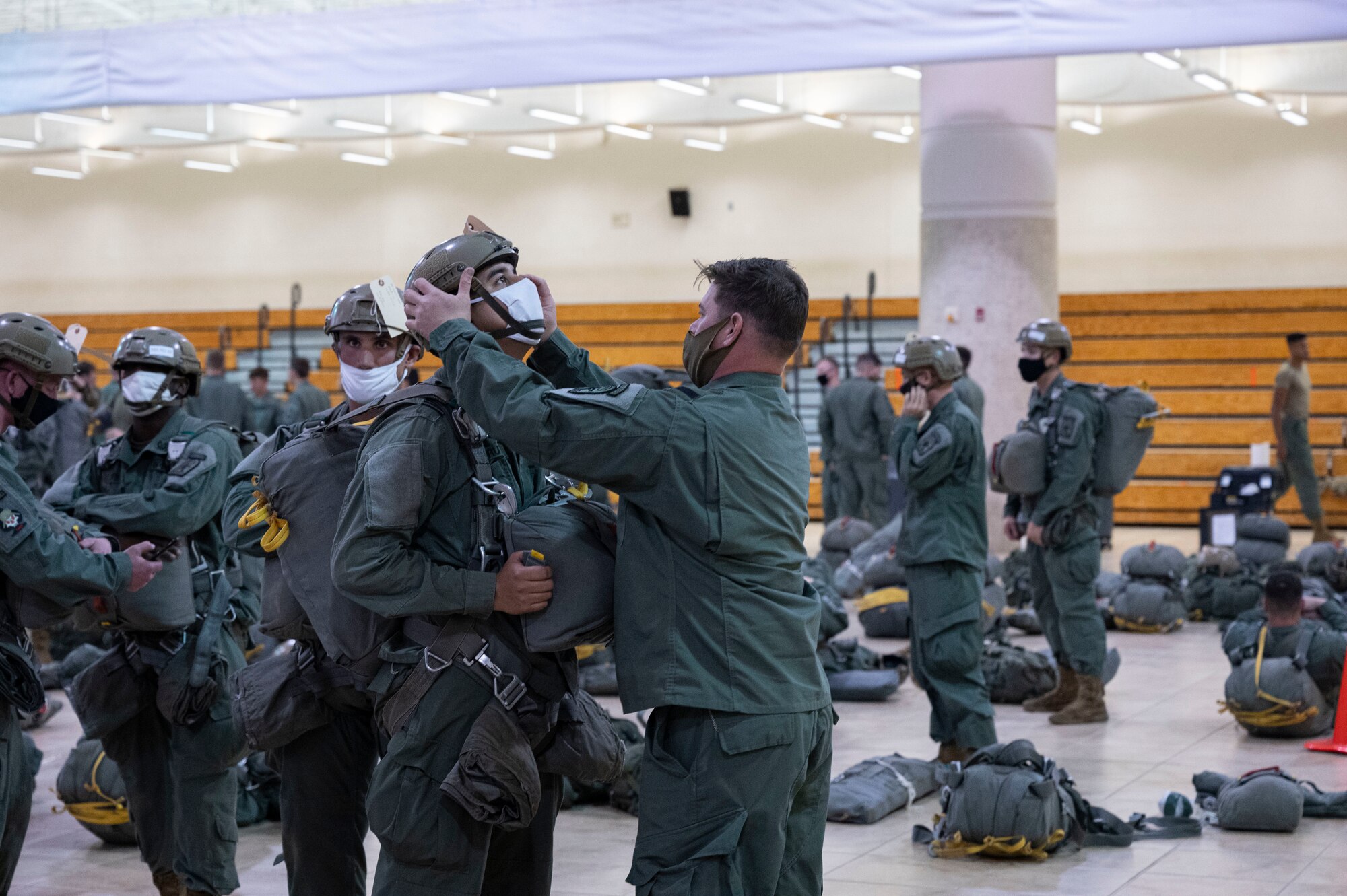 U.S. Army paratroopers from the 1st Battalion, 509th Infantry Regiment, prepare their gear for an airborne operation