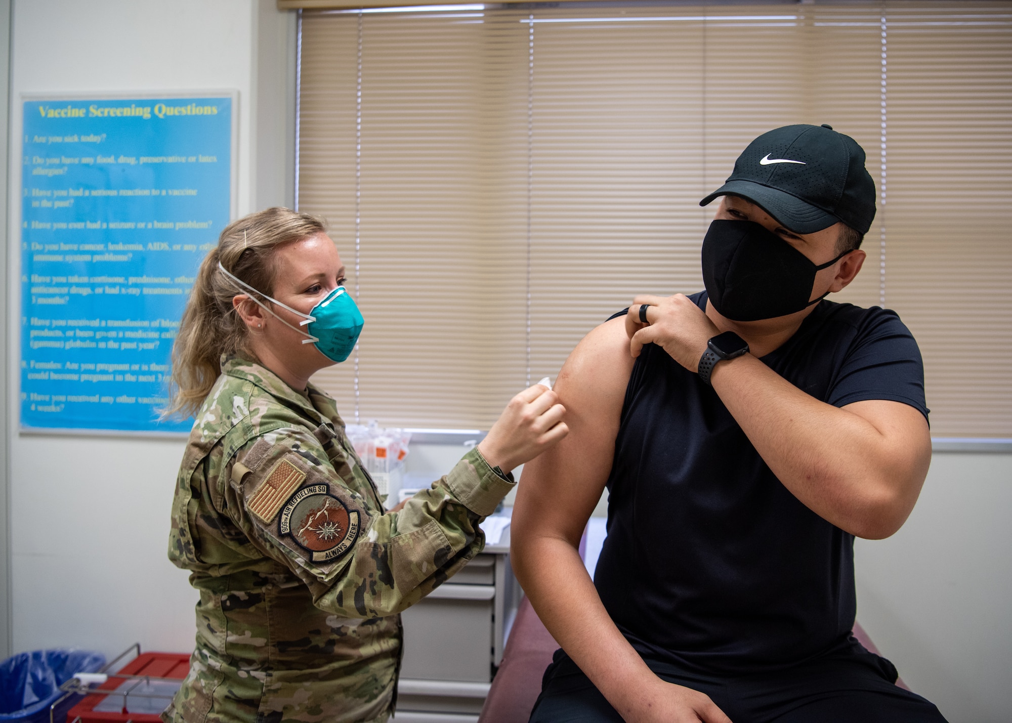 A medical technician administers a COVID-19 vaccine to a patient.