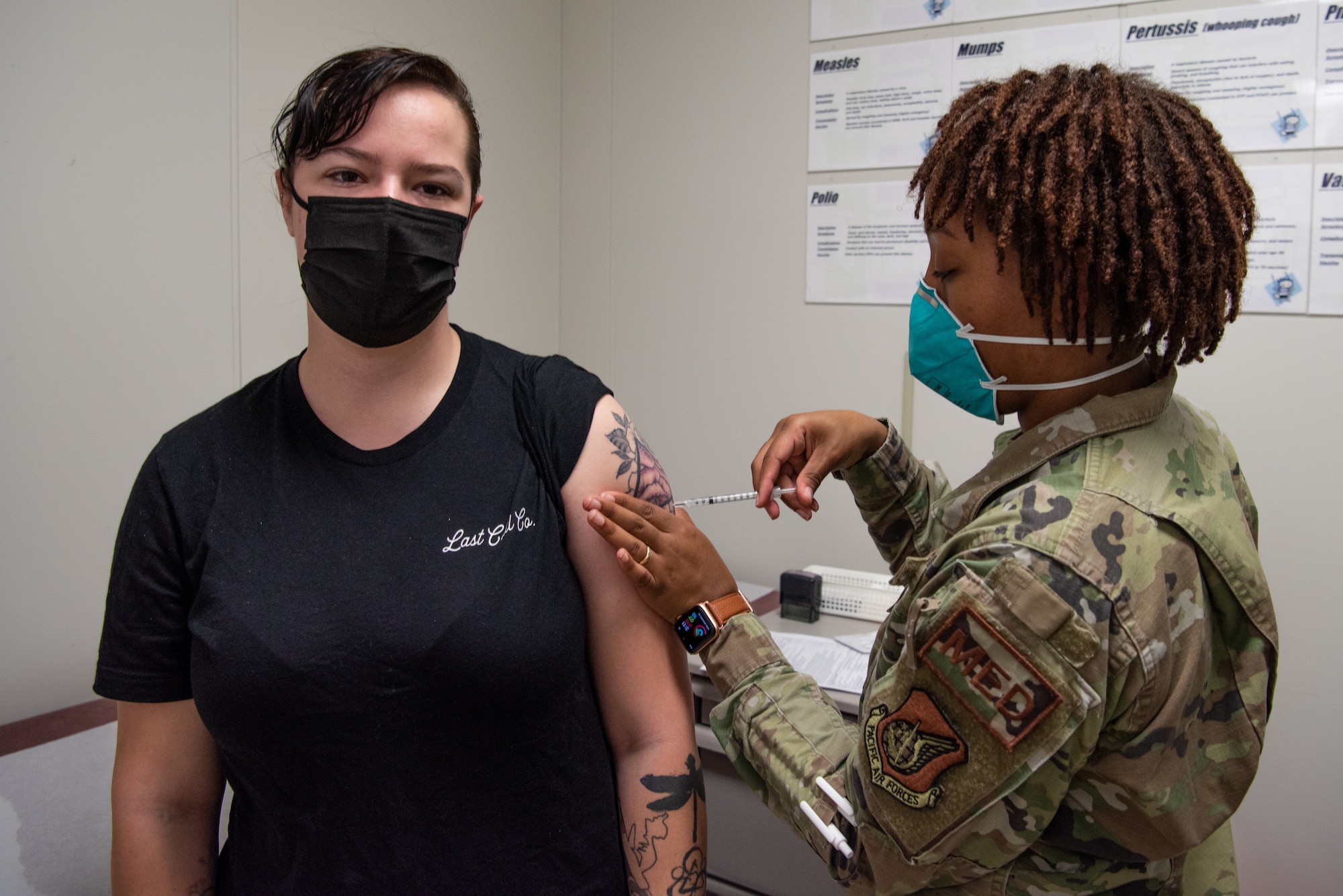 A medical technician administers a COVID-19 vaccine to a patient.
