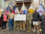 Spc. Monique Tran, left, and Sgt. Mikaela Norton, assigned to 5th Armored Brigade, First Army Division West, pose with members of the Association of the United States Army (AUSA) and the Armed Services YMCA during grant presentation from AUSA to the YMCA in El Paso, Texas, January 21st, 2022.  5th Armored Brigade supports the local community while preparing National Guard and Reserve partners to deploy world wide.  (U.S. Army photo by Capt. Coady Pratt, 5th Armored Brigade)
