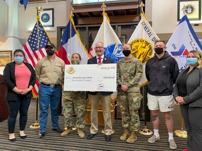 Spc. Monique Tran, left, and Sgt. Mikaela Norton, assigned to 5th Armored Brigade, First Army Division West, pose with members of the Association of the United States Army (AUSA) and the Armed Services YMCA during grant presentation from AUSA to the YMCA in El Paso, Texas, January 21st, 2022.  5th Armored Brigade supports the local community while preparing National Guard and Reserve partners to deploy world wide.  (U.S. Army photo by Capt. Coady Pratt, 5th Armored Brigade)