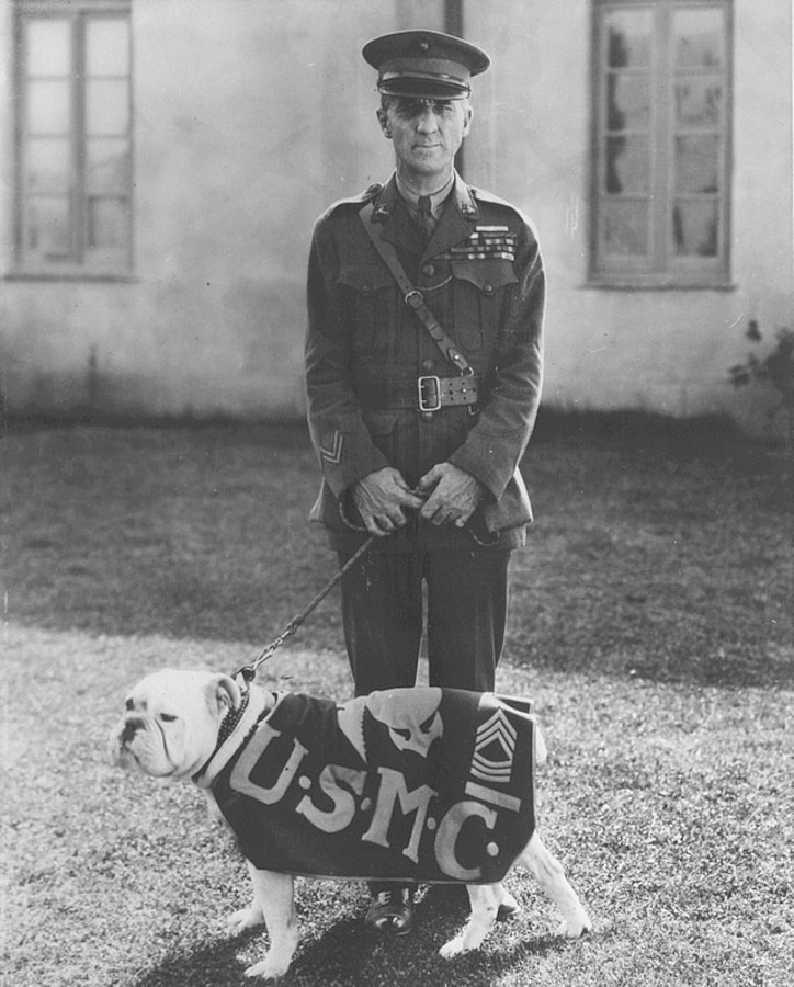 "Two bulldogs of the service, General Smedley D. Butler and "Jiggs" of the Marine Corps, snapped between scenes in the filming of Metro Goldwyn Mayer's "Tell It To the Marines." Circa. 1926.