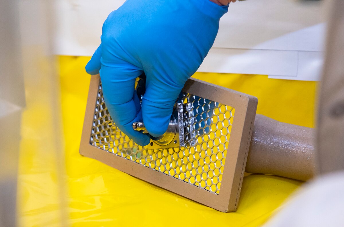 A drift tube module radioactive source cap is tested for radioactive contamination on an alpha probe before being recycled by an Air Force Radioactive Recycling and Disposal team member, Dec. 1, 2021 at Wright-Patterson Air Force Base, Ohio. The source cap is located within a centimeter of the actual radioactive source, and must be surveyed to ensure there is no contamination before releasing it as a recyclable metal. (U.S. Air Force photo by Jaima Fogg)