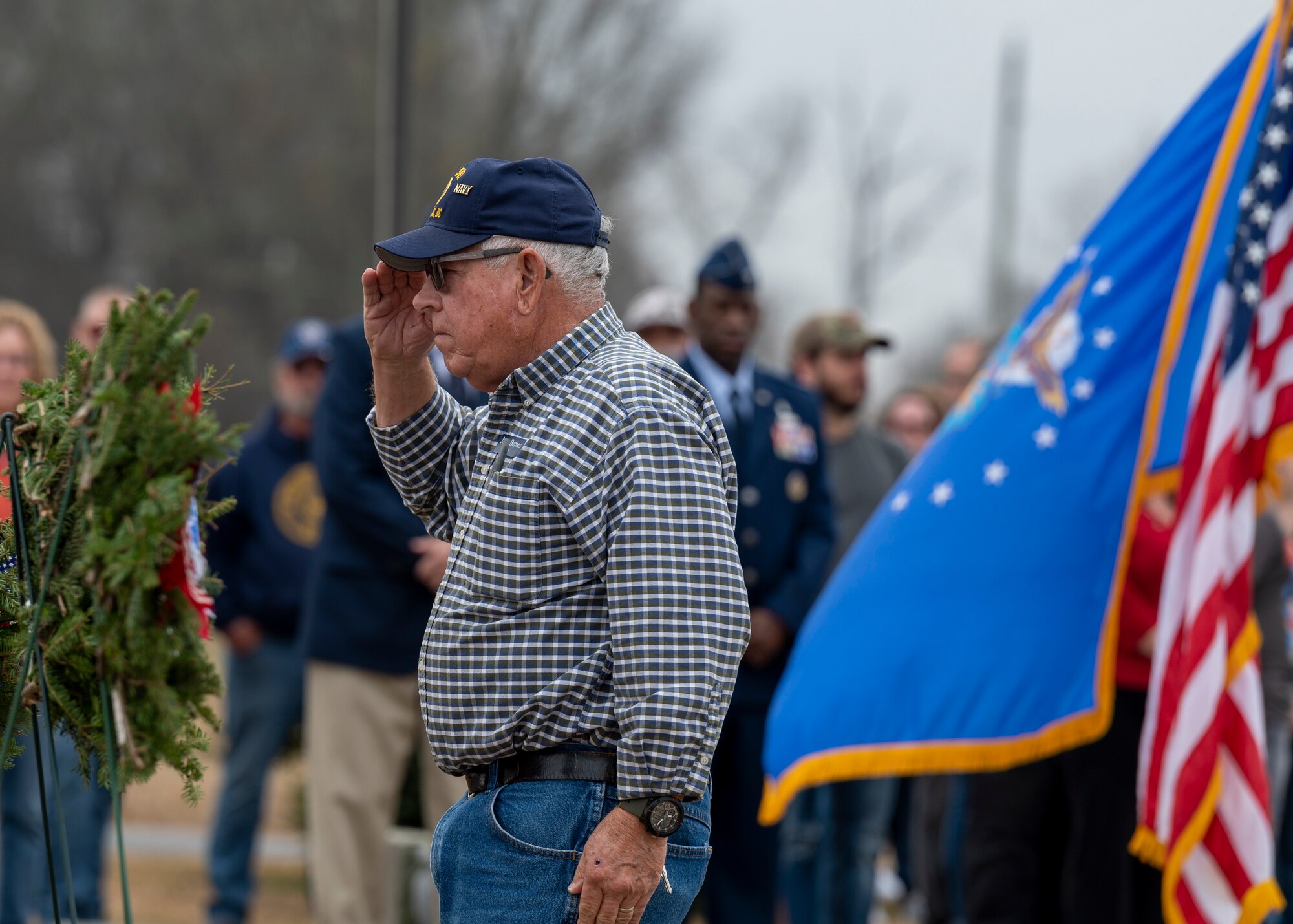 A local veteran salutes while presenting a wreath during a Wreaths Across America ceremony at the Pikeville Cemetery in Pikeville, North Carolina, Dec. 19, 2021.