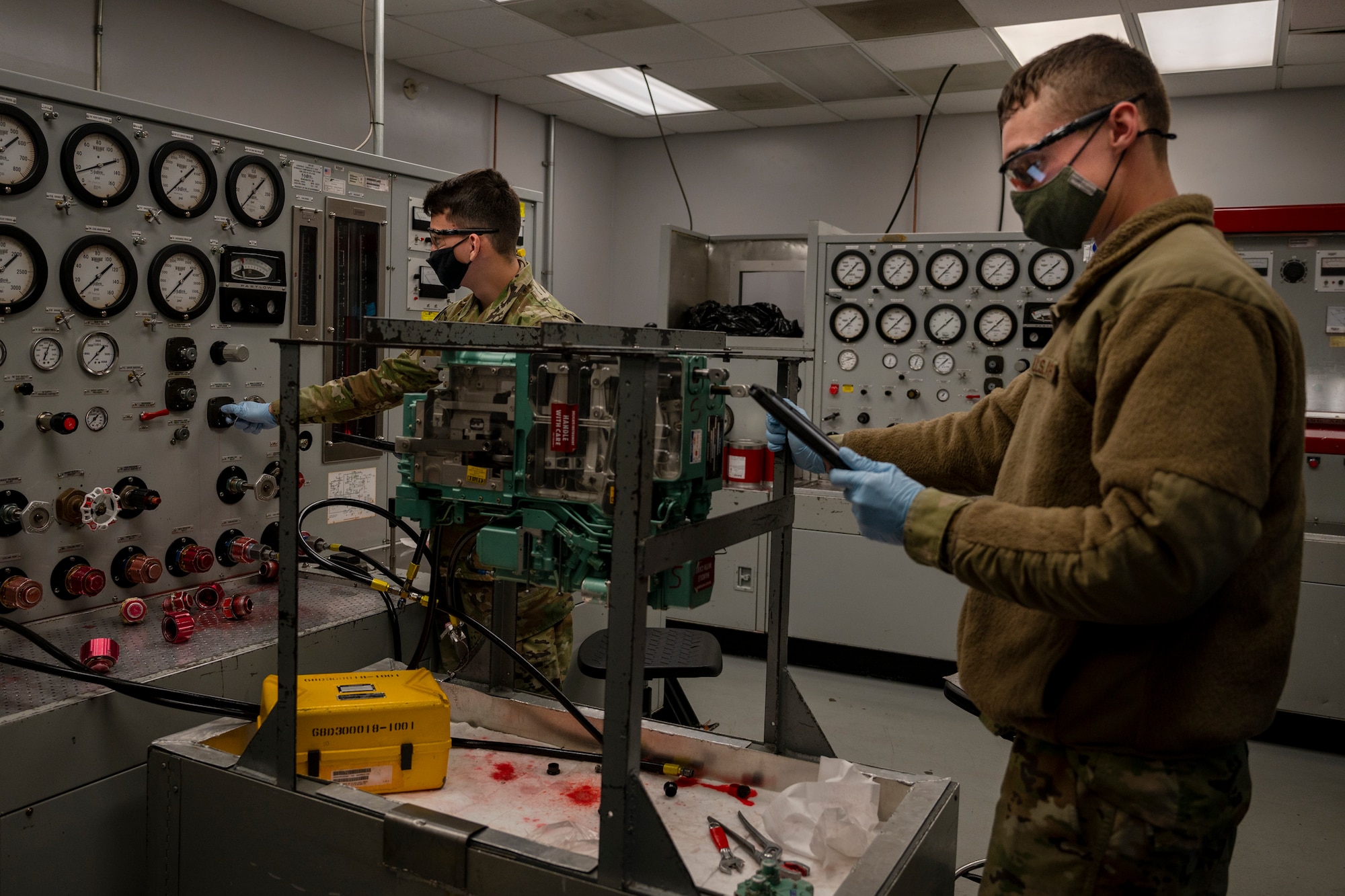 Airman 1st Class Rodolfo Hernandez, left, and Airman 1st Class Dakota Keys, 4th Component Maintenance Squadron hydraulic technician, proof pressure tests a pitch and roll channel assembly for an F-15E Strike Eagle at Seymour Johnson Air Force Base, North Carolina, Dec. 14, 2021.
