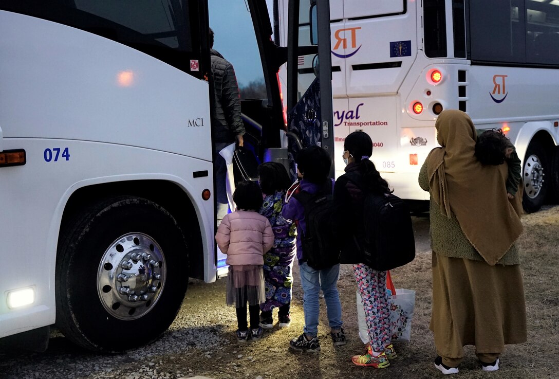 Afghan guests loaded bags into a charter bus to depart to their new homes as their last step in the resettlement process during Operation Allies Welcome, Jan. 7, 2022. Through the Afghan Placement and Assistance Program (APA), individuals are placed in communities across the country to begin rebuilding their lives. This initiative provides essential support at secure locations outside of Afghanistan. The Department of Defense, through U.S. Northern Command, and in support of the Department of Homeland Security, is providing transportation, temporary housing, medical screening, and general support for at least 50,000 Afghan evacuees at suitable facilities in permanent or temporary structures as quickly as possible. (U.S. Army photo by Sgt. Trinity Carter)