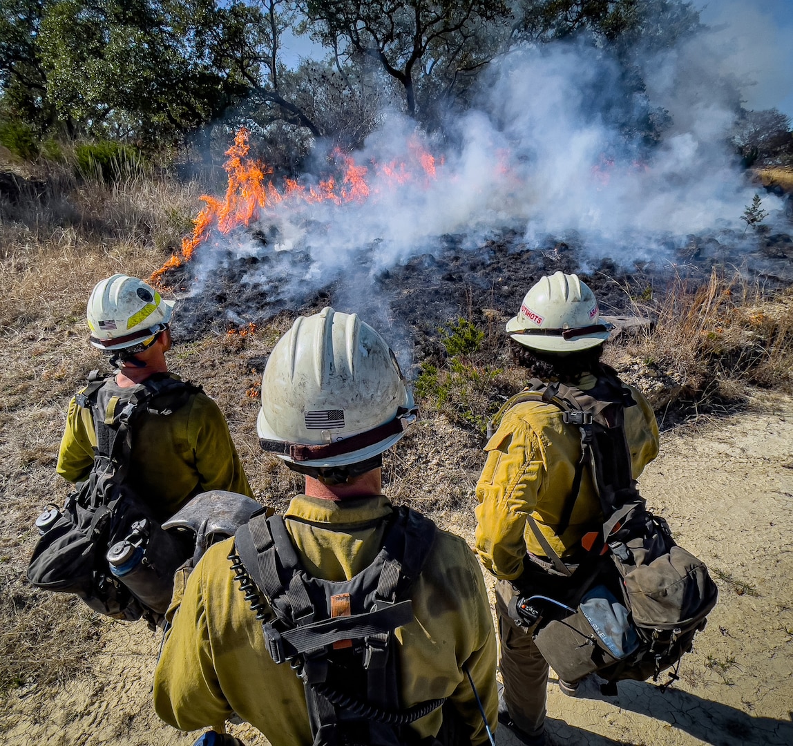 Members of Joint Base San Antonio’s Natural Resources Office, Fire & Emergency Services, and Air Force Wildland Fire Branch officials conduct a prescribed burn