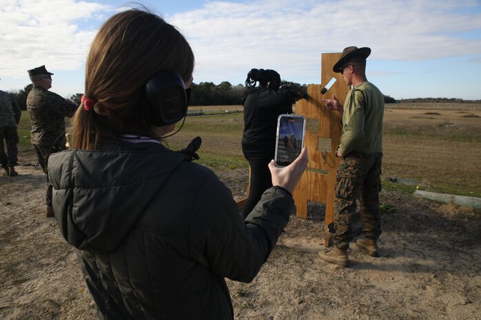 Emily Pettaway, the dean of academics for St. Louis Catholic High School of Lake Charles, Louisiana, takes a video of Kayla Jackson, an Algebra I teacher at Ponchatoula High School of Ponchatoula, Louisiana, firing an M16A4 service rifle during an Educators Workshop aboard Marine Corps Recruit Depot Parris Island, S.C., Jan. 12, 2022. Marine Corps Recruiting Command provides educators workshops as an opportunity for teachers, principals, counselors, coaches and media to experience the basic training process first-hand. The workshops are one of many ways for the attendees to learn about the multitude of opportunities the Marine Corps can provide to young men and women within their communities.