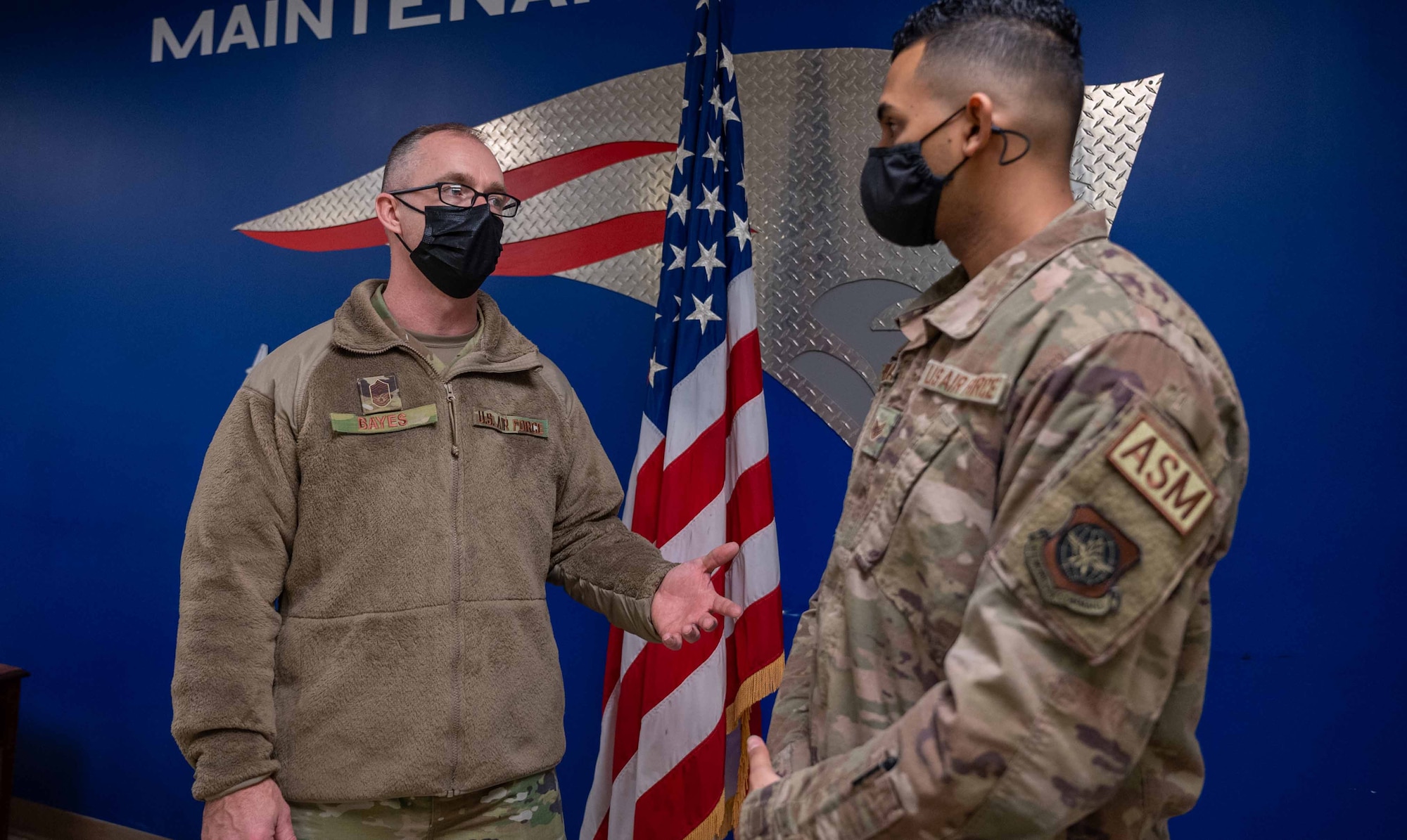 Chief Master Sgt. Tim Bayes (left), 436th Air-lift Wing command chief, speaks with Staff Sgt. James Cuevas, 436th Maintenance Squadron, Operating Location Alpha sheet metal journeyman, at Westover Air Reserve Base, Massachusetts, Jan. 25, 2022. During their visit to WARB, Bayes and Col. Matt Husemann, 436th AW commander, toured the C-5 Isochronal Maintenance Dock and gave an all call to members of the squadron. (U.S. Air Force pho-to by Senior Airman Faith Schaefer)