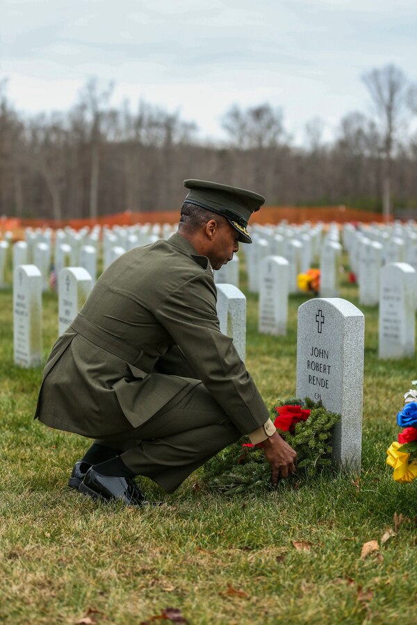 U.S. Marine Corps Col. Michael L. Brooks, commanding officer, Marine Corps Base Quantico, lays a wreath on the gravestone of a fallen service member during the Wreaths Across America event at Quantico National Cemetery in Triangle, Virginia, Dec. 18, 2021. The event is held in unity with national cemeteries nationwide to honor the military and their families who have served.(U.S. Marine Corps photo by Lance Cpl. Addysyn Tobar)