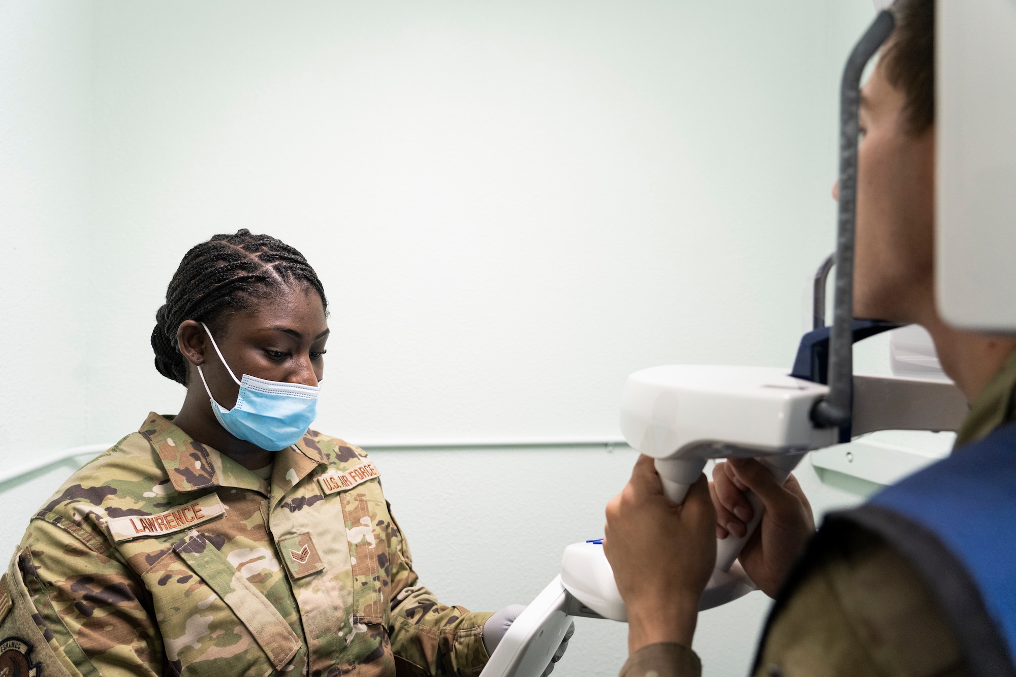 Airman uses interface of X-ray machine.