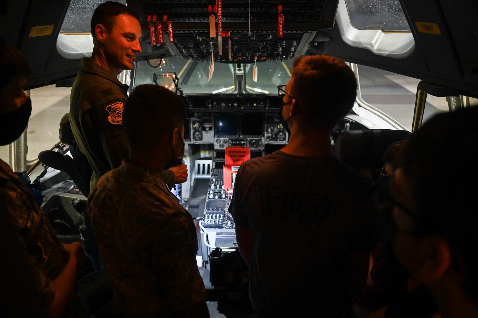 Col. Garrett Fisher, 15th Operations Group commander, demonstrates flight panel operation on a C-17 Globemaster III to Hawaii Wing Civil Air Patrol cadets at Joint Base Pearl Habor-Hickam, Hawaii, Jan. 25, 2022. CAP members were able to explore the fuselage, flight deck and exterior of the aircraft during the tour. (U.S. Air Force photo by Staff Sgt. Alan Ricker)