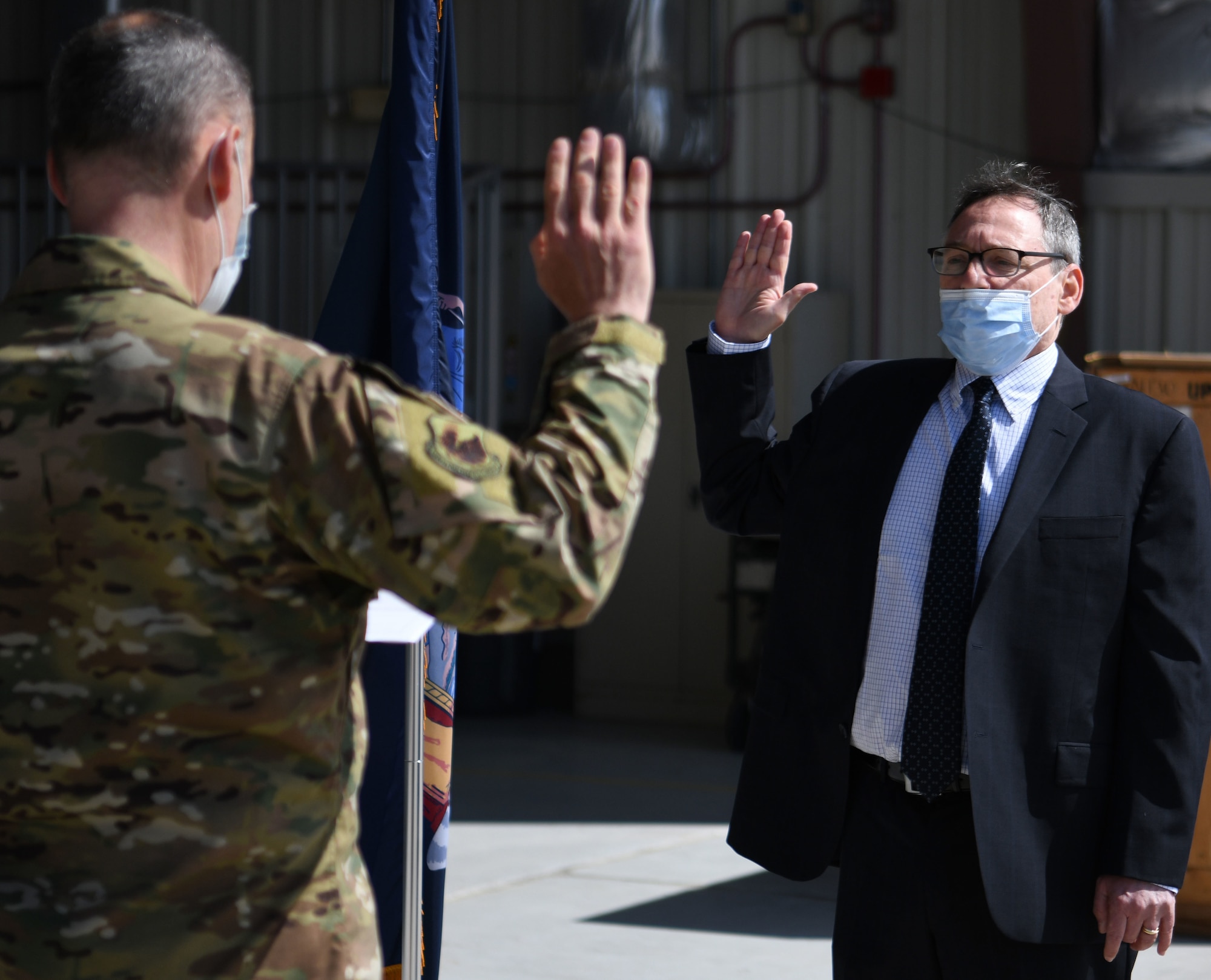 New York Air National Guard Lt. Col. Steven " Doc" Rush, commander of the 106th Medical Group, administers the oath to Dr. David M. Feldman, age 62, who was commissioned as a lieutenant colonel in the 106th Rescue Wing at Gabreski Air National Guard Base on May 25, 2021. The wing worked to get a waiver for Feldman's ago to allow the experienced doctor to become a flight surgeon. (US Air National Guard Photo by Senior Airman Dan Farrell)