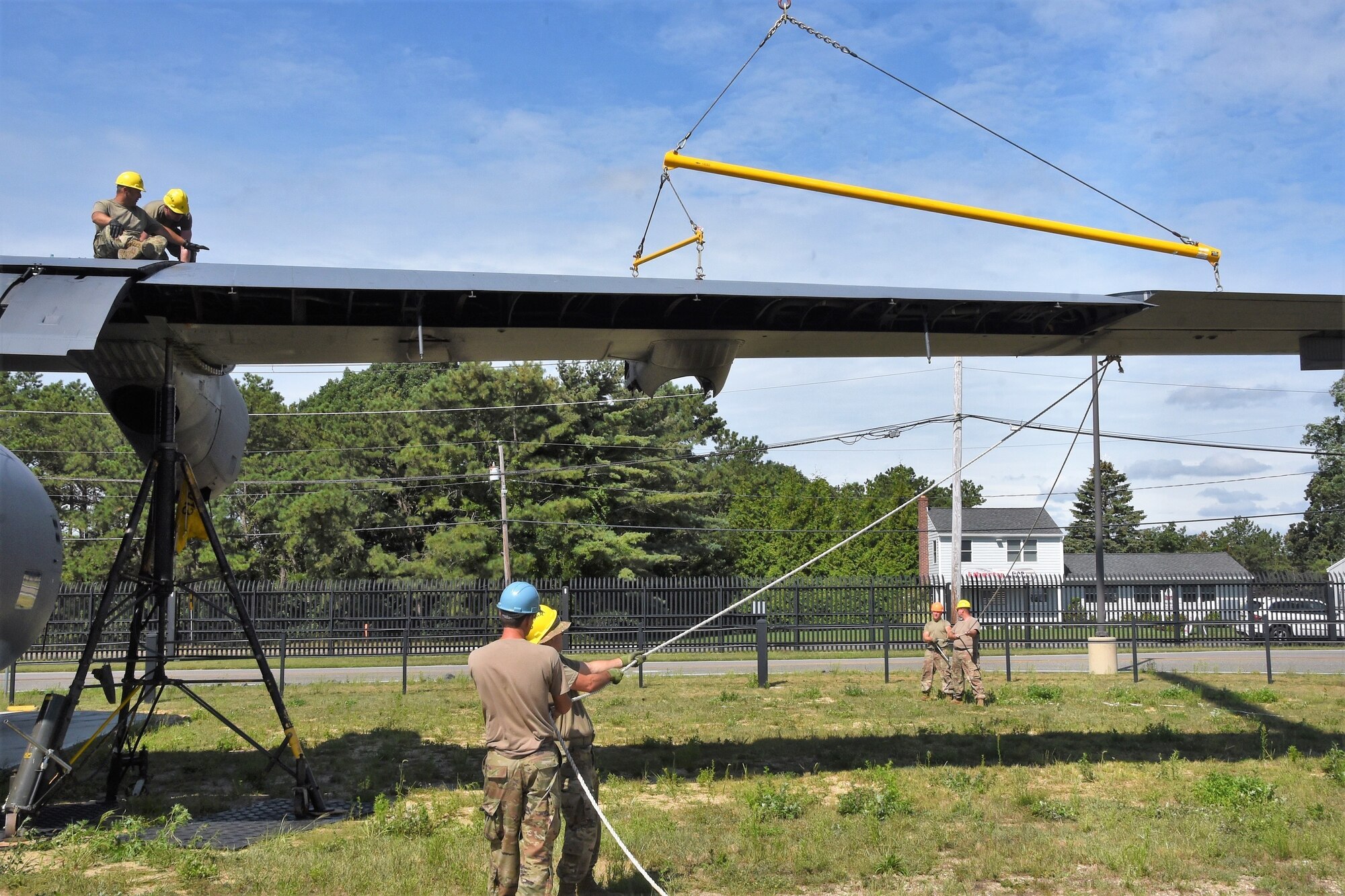 Airmen reassemble the wings of a CH-130 Hercules search and rescue aircraft known as "The Spirit of Long Island" and Triple Deuce for its 0222-tail number, after it was moved into position at the gate of F.S. Gabreski Air National Guard Base in Westhampton Beach, New York on August 17, 2021. The aircraft served for over 50 years, finishing its service with the New York Air National Guard's 106th Rescue Wing. (U.S. Air National Guard Photo by Mark Getman)